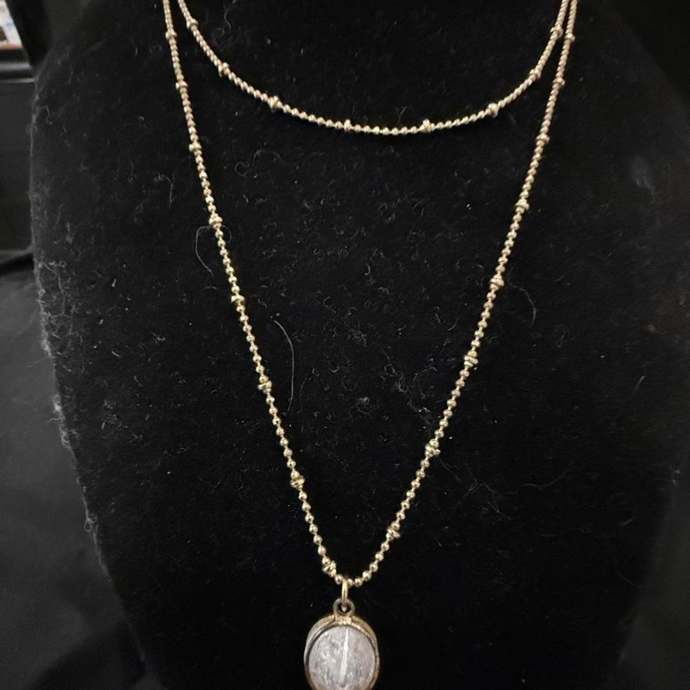 Gold tone layered necklace with white crystal pendant